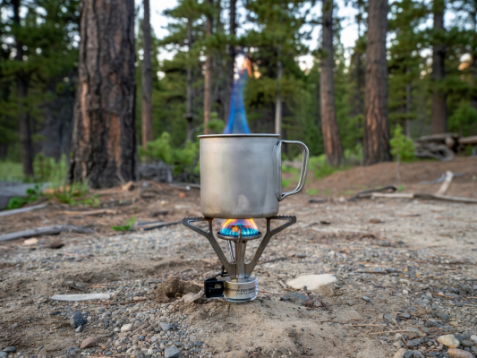 Titanium cooking mug on outdoor camping stove
